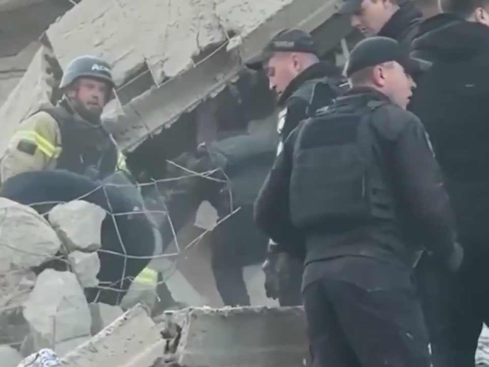 Rescuers search the rubble