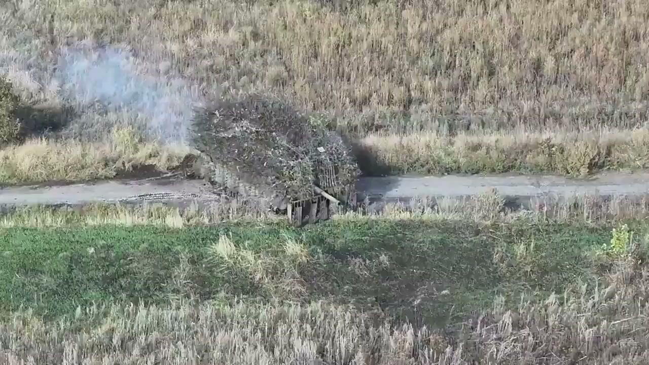 A cage-armored tank on the move (video still)