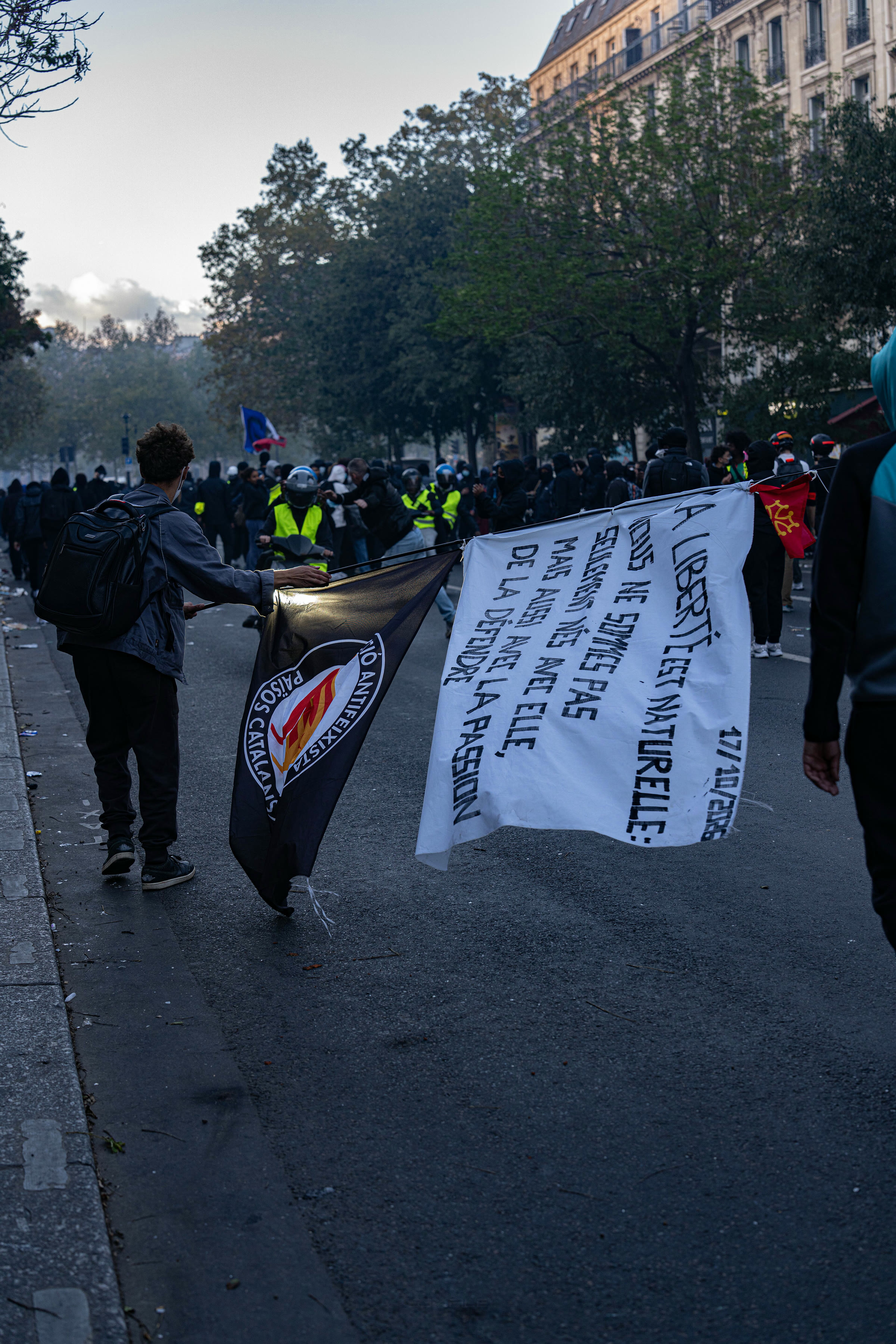 Protesters carry a banner in a Paris street on Oct. 17