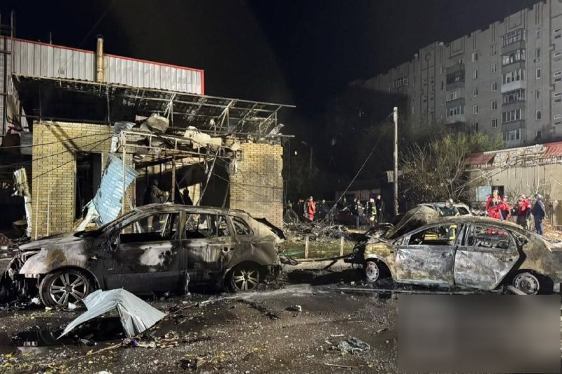 Burned-out cars near high-rise apartment buildings